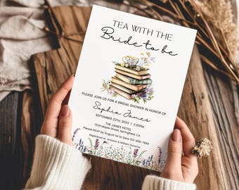 May include: A white rectangular bridal shower invitation card featuring a watercolor illustration of a stack of books topped with a teacup and flowers. The text reads TEA WITH THE BRIDE TO BE, Sophia James, September 23rd, 20XX, 2:30PM, The James Hotel, 1234 Maple Street, Springfield, CA, RSVP by August 1st to Sara 123-456-7890, Registered at Amazon & William Sonoma.