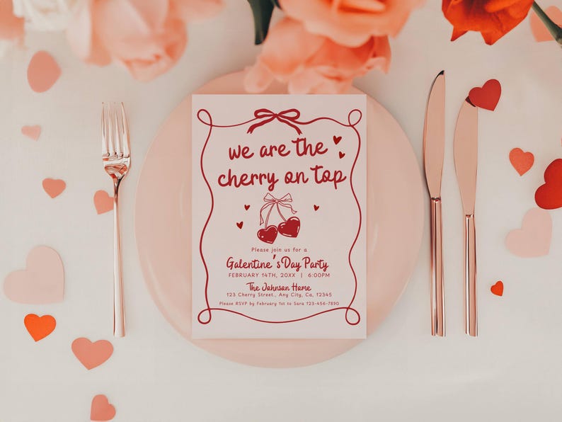 May include: A Valentine's Day party invitation with the text "we are the cherry on top" in red script. The invitation is on a pink plate, with a fork and knives. Scattered heart-shaped confetti and flowers complete the romantic setting.
