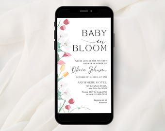 May include: A smartphone displaying a baby shower invitation with the text BABY IN BLOOM, Olivia Johnson, October 12th, 20XX, at 3PM, Anywhere Hotel, 123 Anywhere Street, Any City, CA, 12345, RSVP by August 1st to Sara 123-456-7890, and Amazon.