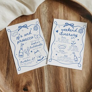 May include: Two white cards with blue illustrations and text. The first card says "pj's and prosecco" and the second card says "weekend itinerary".