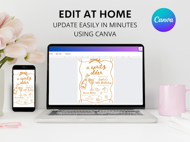 May include: A laptop, smartphone, and a pink mug are on a white surface. The laptop and smartphone display a birthday invitation design with the text "a spritz older". The invitation is orange on a white background. The text "EDIT AT HOME" is at the top.