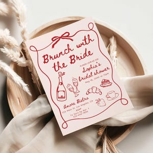 May include: A pink bridal shower invitation with red text that reads "Brunch with the Bride" and includes details for Sophia's bridal shower. The invitation features illustrations of champagne, pastries, and a strawberry.