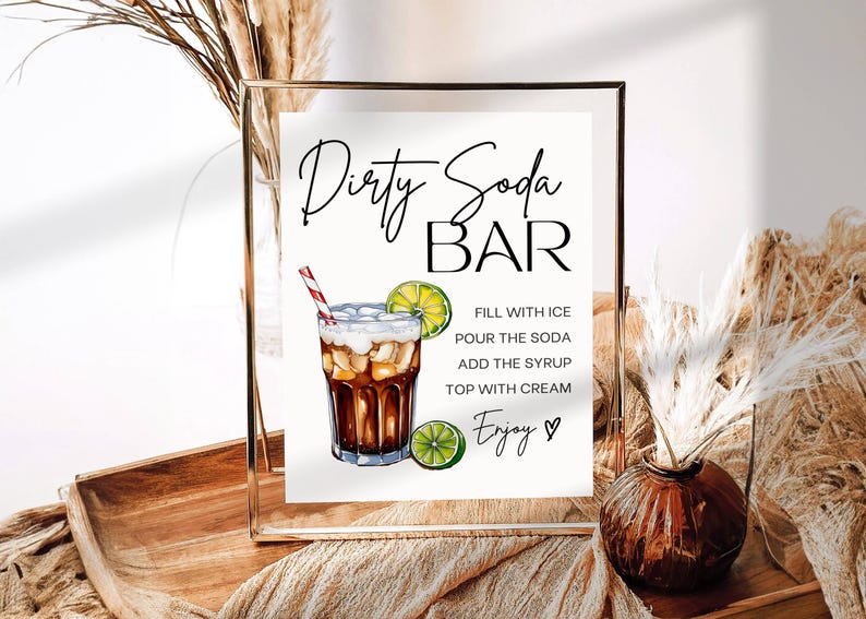 May include: A printable sign for a "Dirty Soda Bar" with instructions on how to make the drink. The sign features a hand-drawn illustration of a glass of dirty soda with a lime wedge and a red and white striped straw.