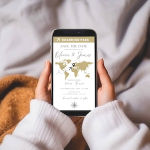 May include: A smartphone screen displays a save the date announcement for a wedding. The announcement is styled like a boarding pass with a world map and the text "Save the Date for the Wedding of Olivia & James. Destination: Paris, France. October 12th, 2023, at 3PM."