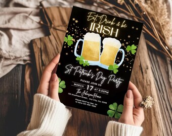 May include: A black rectangular party invitation card featuring two beer mugs with foam, green shamrocks, and gold stars. The text reads: Eat, Drink & be IRISH, St. Patrick's Day Party, PLEASE JOIN US, MARCH 17 AT 6:00PM, The Johnson Home, 123 Anywhere Street, Any City, Ca, 12345, Please RSVP by Dec. 1st to Sara 123-456-7890.