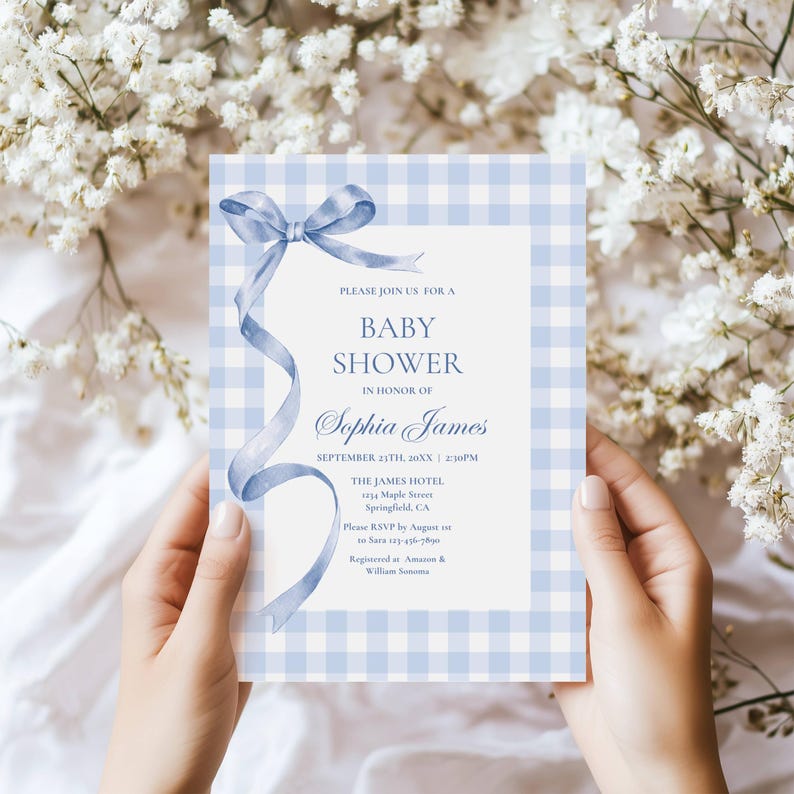 May include: A baby shower invitation with a blue gingham pattern and a watercolor ribbon design. The invitation includes the text "Baby Shower" and details for the event, including the name "Sophia James", date, time, and location.