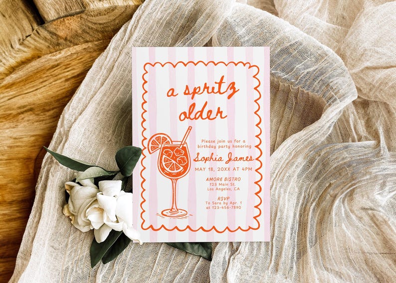 May include: A pink and white striped invitation with the words "a spritz older" in orange script. The invitation includes details for a birthday party, featuring a cocktail illustration.
