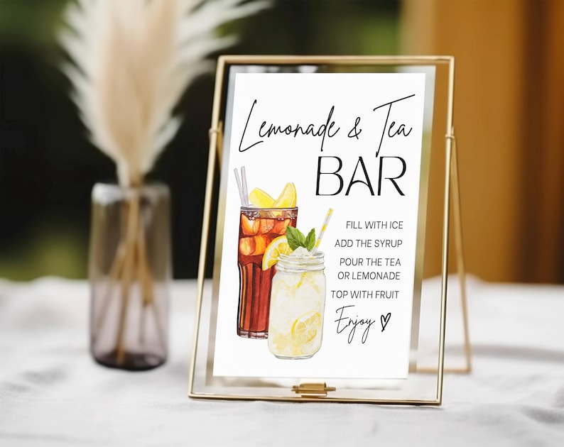 May include: A gold-framed sign with the words "Lemonade & Tea BAR" in black script. The sign features watercolor illustrations of iced tea and lemonade, with instructions and the word "Enjoy!" in script.