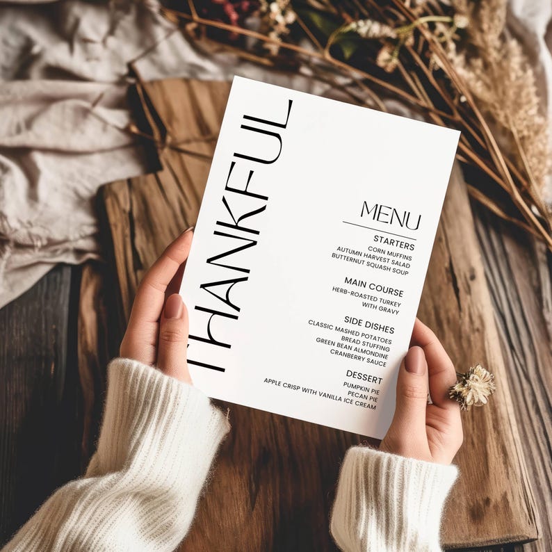 May include: A Thanksgiving menu with the word "THANKFUL" in large black letters at the top. The menu lists starters, main course, side dishes, and dessert. The menu includes items like corn muffins, butternut squash soup, herb-roasted turkey, mashed potatoes, bread stuffing, cranberry sauce, pumpkin pie, and pecan pie.