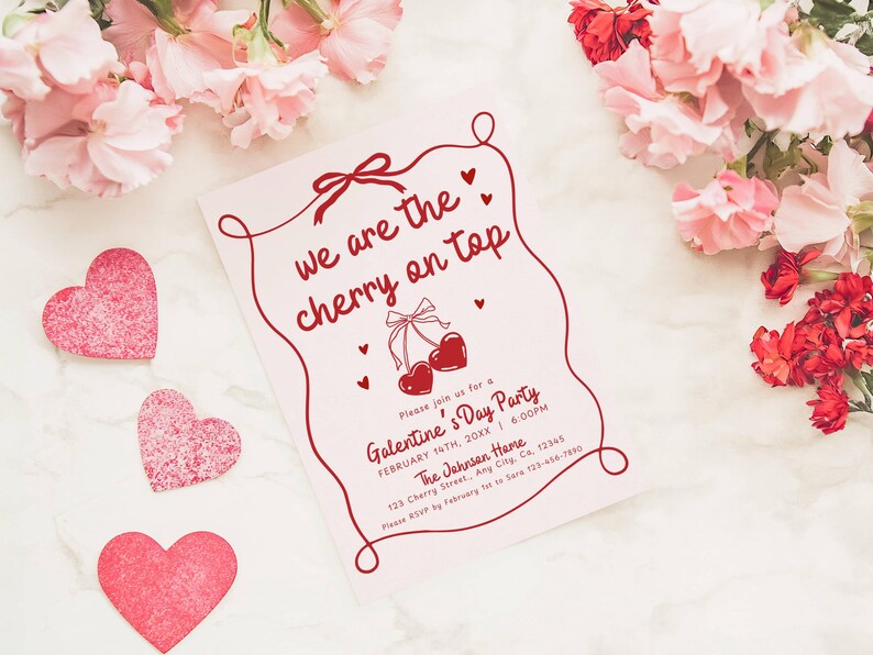 May include: A pink Galentine's Day party invitation with the text "we are the cherry on top" in red script. The invitation features a cherry illustration and heart accents. Pink paper hearts and flowers surround the invitation.