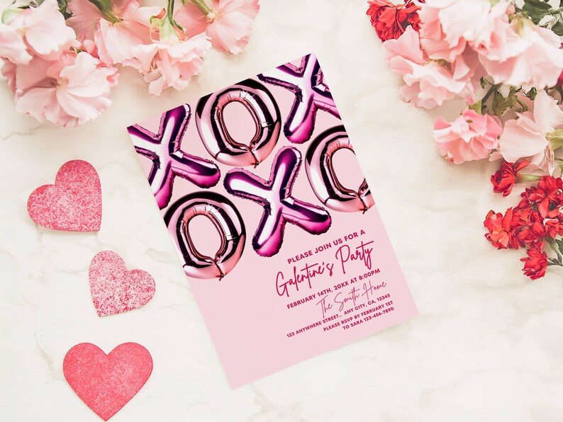 May include: Pink Galentine's Party invitation with foil balloon-style "XOXO" design. The invitation includes event details: date, time, and location. Decorative pink hearts and flowers surround the invitation on a marble surface.