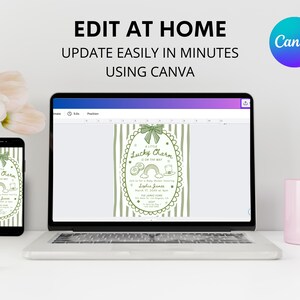 May include: A laptop, smartphone, and a pink mug are on a white desk. The laptop and smartphone display a green and white invitation design with the text "A Little Lucky Charm is on the way." The text "Edit at Home, Update Easily in Minutes Using Canva" is at the top.
