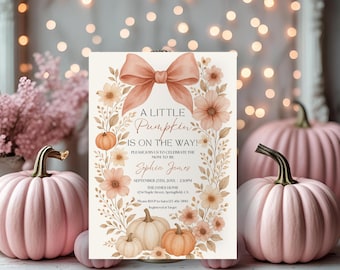 May include: A rectangular baby shower invitation card featuring a large peach-colored bow at the top, surrounded by a floral and pumpkin wreath. The text reads: A LITTLE PUMPKIN IS ON THE WAY! PLEASE JOIN US TO CELEBRATE THE MOM-TO-BE Sophia James SEPTEMBER 23TH, 20XX | 2:30PM THE JAMES HOME 1234 Maple Street, Springfield, CA Please RSVP to Sara 123-456-7890 Registered at Target.