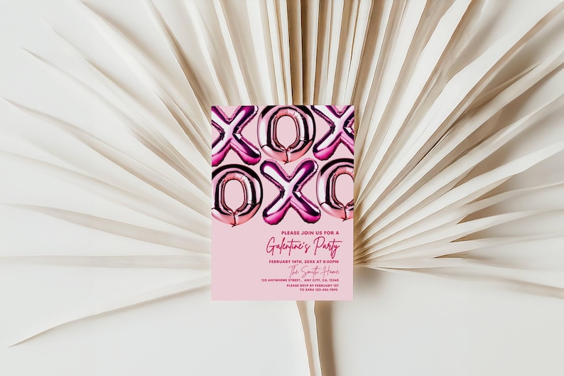 May include: A pink invitation card with the text "XOX" in metallic pink balloon letters. The card reads "Please join us for a Galentine's Party" with event details. The card is set against a backdrop of white, textured palm leaves.