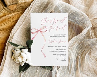 May include: A white bridal shower invitation card featuring a pink ribbon illustration and the text She's tying the knot, honoring Sophia James on September 23rd, 20XX, at 2:30 PM at The James Home, 1234 Maple Street, Springfield, CA.