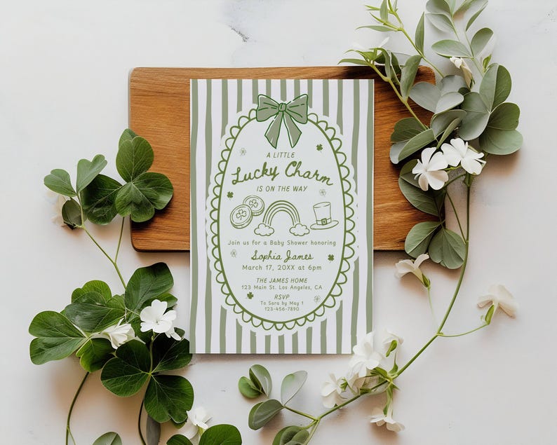 May include: A baby shower invitation with a St. Patrick's Day theme. The invitation features a green and white striped background with a decorative border and the text "A Little Lucky Charm Is On The Way". The invitation includes the name "Sophia James" and event details.