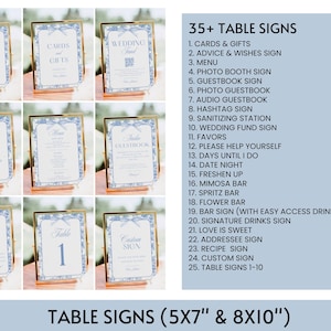Op de afbeelding: Een verzameling van meer dan 35 tafelschilderingen voor een bruiloft. De schilderingen zijn in gouden frames met blauwe en witte bloemenmotieven. De schilderingen omvatten "Kaarten & Cadeaus", "Wensen & Gelukswensen Schild", "Menu", "Fotohokje Schild", "Gastenboek Schild", "Foto Gastenboek", "Audio Gastenboek", "Hashtag Schild", "Desinfectie Station", "Bruiloft Fonds Schild", "Favorieten", "Neem gerust", "Dagen Tot De Bruiloft", "Avondeten", "Fris Jezelf Op", "Mimosa Bar", "Spritz Bar", "Bloemenbar", "Bar Schild (met gemakkelijk toegankelijke drank afbeeldingen)", "Handtekening Drankjes Schild", "Liefde Is Zoet", "Adres Schild", "Recept Schild", "Aangepast Schild" en "Tafelschilderingen 1-10".
