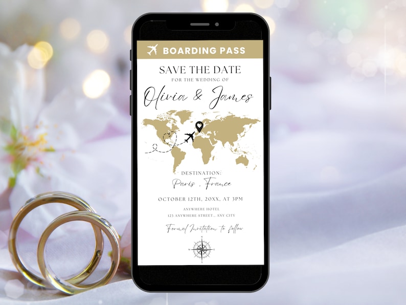 May include: A smartphone screen displaying a save the date announcement for Olivia & James' wedding in Paris, France on October 12th. The announcement features a world map with a plane and heart icon, and the text "Boarding Pass" at the top.