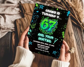 May include: A rectangular birthday invitation card with a black background, featuring neon green and blue paint splatter designs, star and crown icons, and the text: JAMES IS TURNING 7... 67 AND YOUR INVITED, OCTOBER 20TH, 20XX, AT 3PM, THE SMITH HOME.