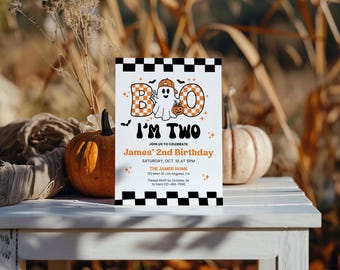 May include: A rectangular birthday invitation card featuring a black and white checkered border, a ghost wearing an orange cap, and the text BOO I'M TWO, James' 2nd Birthday, Saturday, Oct. 18 at 5PM, The James Home, 123 Main St, Los Angeles, CA.