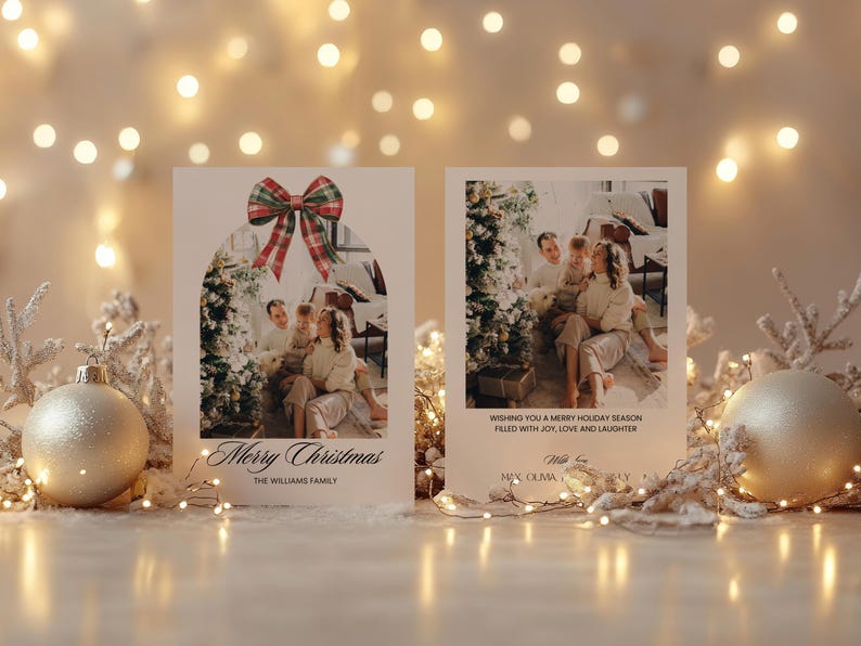 May include: Two Christmas cards with a festive red and green bow on the top. The card on the left has a photo of a family in front of a Christmas tree. The card on the right has a photo of a family in front of a Christmas tree and the text "Wishing you a Merry Holiday Season filled with joy, love and laughter".