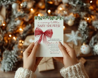 May include: A rectangular white invitation card featuring a large red sheer ribbon graphic, green pine branch accents, and text reading A merry little BABY SHOWER, PLEASE JOIN US FOR A BRIDAL SHOWER IN HONOR OF Sophia James, DECEMBER 19TH, 20XX, THE JAMES HOME.