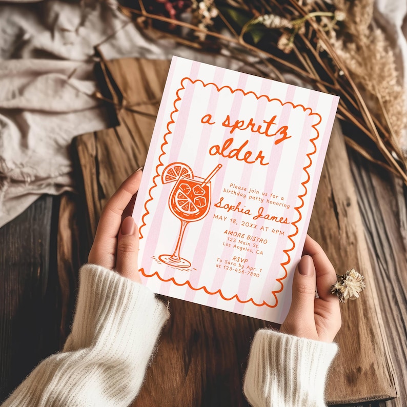 May include: A pink and white striped invitation with the text "a spritz older" and a cocktail illustration. The invitation is for a birthday party honoring Sophia James, with details including the date, time, and location.