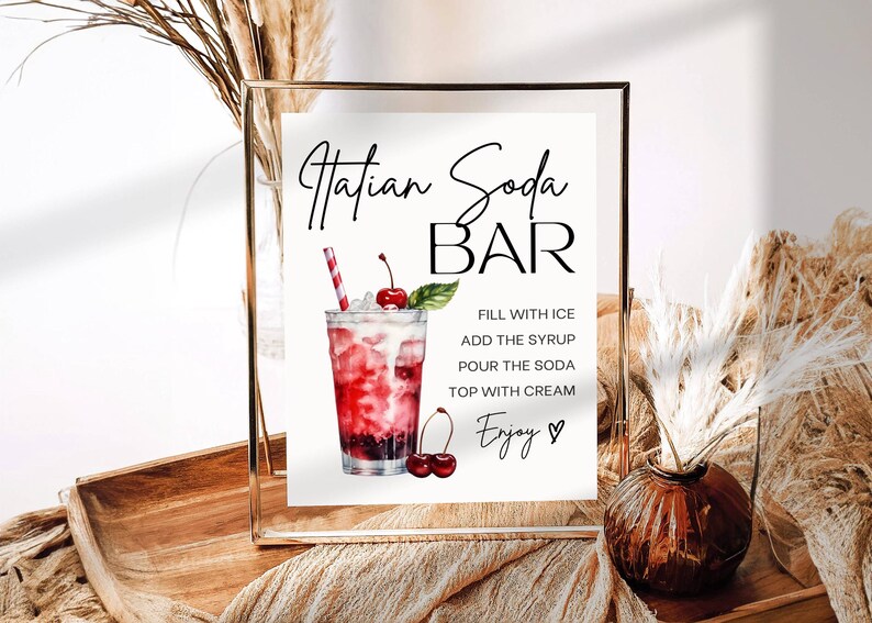 Op de afbeelding: Een printbaar bord voor een "Hatian Soda Bar" met een aquarel-illustratie van een glas soda met een kers en instructies voor het maken van de drank. De tekst luidt "Vul met ijs, voeg de siroop toe, giet de soda, top met room, Geniet."