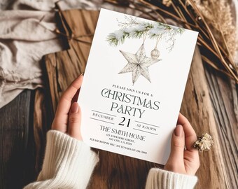 Può includere: Un invito bianco per una festa di Natale con un'illustrazione ad acquerello di una stella e rami di pino. Il testo recita: Please join us for a Christmas party, December 21 at 8:00 PM, The Smith Home, 123 Anywhere Street.