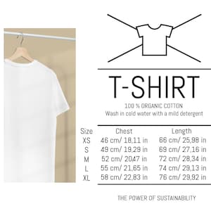 May include: White t-shirt on a hanger with a size chart showing chest and length measurements in inches and centimeters for sizes XS, S, M, L, and XL. The chart also states that the t-shirt is made of 100% organic cotton and should be washed in cold water with a mild detergent. The text "THE POWER OF SUSTAINABILITY" is at the bottom of the chart.