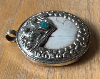 Shell Tibetan Pendant with Deer and howlite Turquoise in the center.