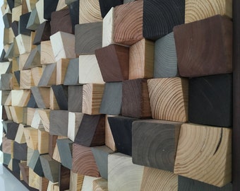 May include: A wall art piece made of various sized wooden blocks in different shades of brown, gray, and black. The blocks are arranged in a geometric pattern, creating a textured and modern look.