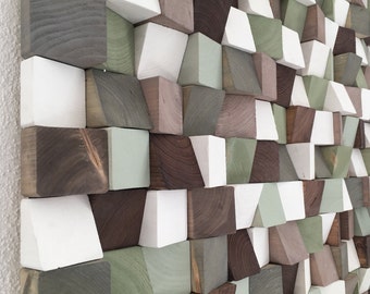 May include: A wall art piece made of various wooden blocks in shades of brown, white, and green. The blocks are arranged in a geometric pattern, creating a modern and abstract design.