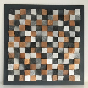 May include: A wall art piece made of wood blocks in various shades of gray, white, and brown. The blocks are arranged in a checkered pattern and create a 3D effect.