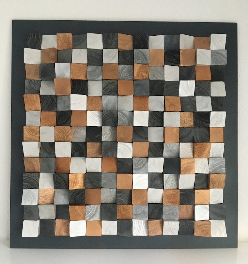 May include: A wall art piece made of wood blocks in various shades of gray, white, and brown. The blocks are arranged in a checkered pattern and create a 3D effect.