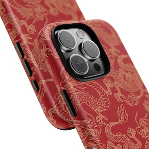 May include: Red phone case with a gold dragon design. The case has a raised camera bump with a black trim.