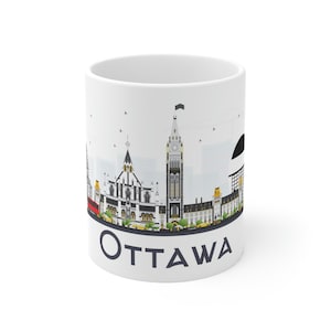 May include: White ceramic mug with a black and white illustration of the Ottawa skyline. The mug has the word "OTTAWA" printed in navy blue at the bottom.
