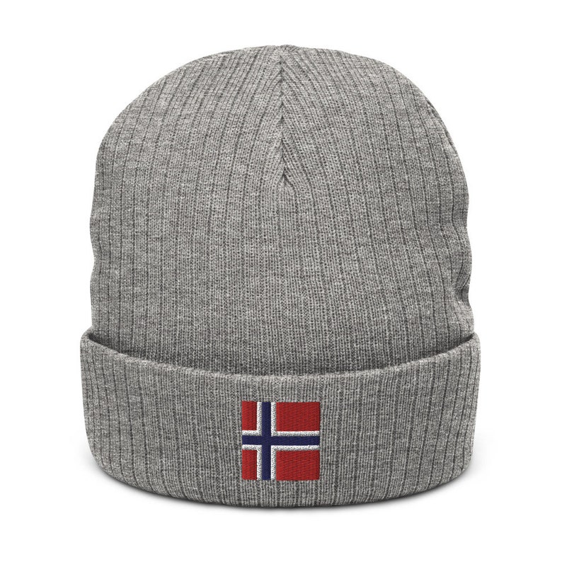 May include: Gray knitted beanie with a small embroidered Norwegian flag on the front.