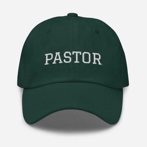 May include: A dark green baseball cap with the word "PASTOR" embroidered in white on the front.