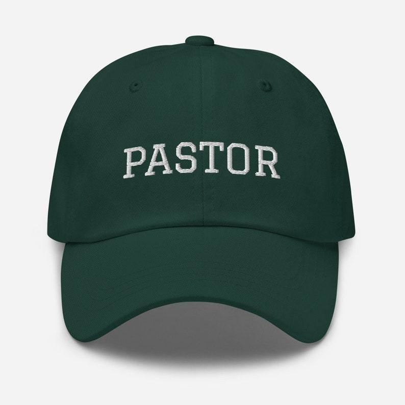 May include: A dark green baseball cap with the word "PASTOR" embroidered in white on the front.