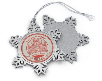May include: Silver snowflake ornament with a red and white image of the Duomo di Milano, a cathedral in Milan, Italy. The ornament has a silver string for hanging.