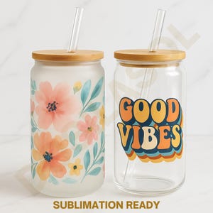 May include: Two glass tumblers with bamboo lids and clear straws. One tumbler is frosted with a floral design in peach, pink, and blue. The other is clear with a retro "Good Vibes" graphic in orange, yellow, and blue. "Sublimation Ready" text is at the bottom.