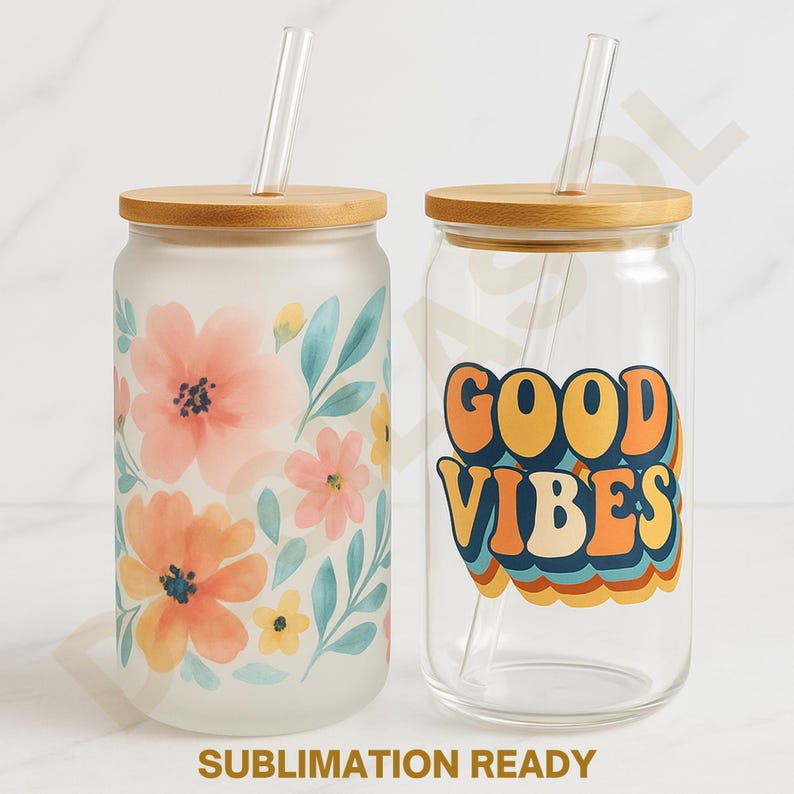 May include: Two glass tumblers with bamboo lids and clear straws. One tumbler is frosted with a floral design in peach, pink, and blue. The other is clear with a retro "Good Vibes" graphic in orange, yellow, and blue. "Sublimation Ready" text is at the bottom.