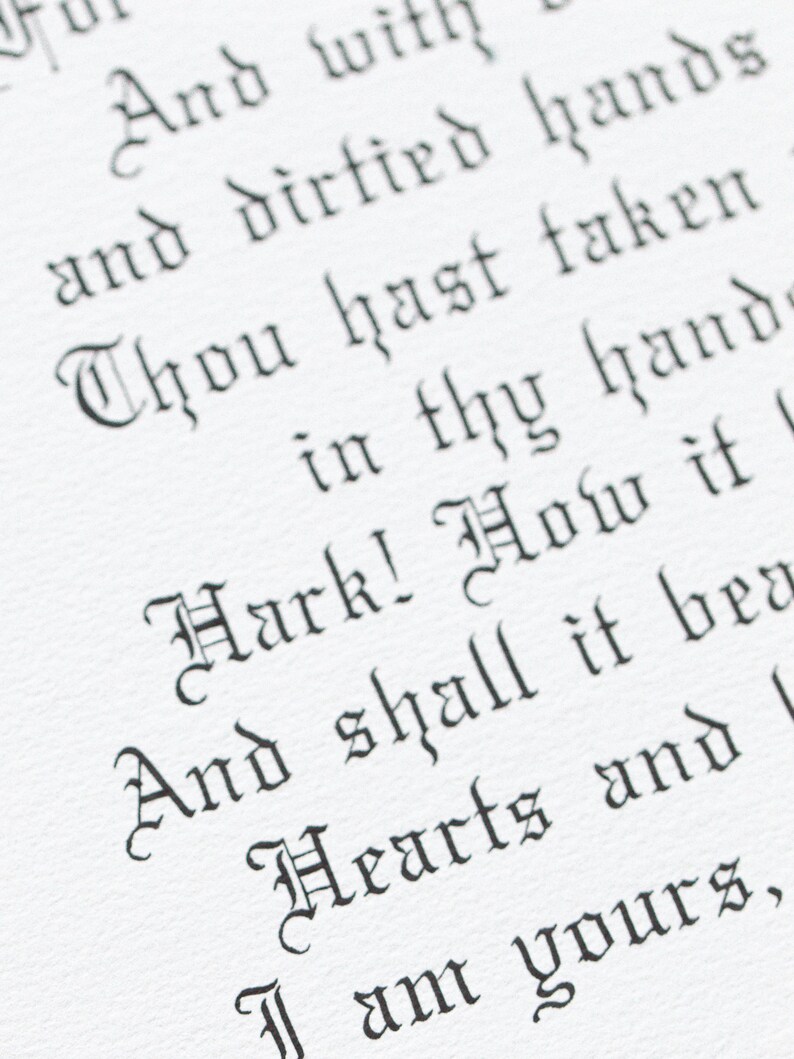 May include: Close-up of a white paper with black gothic script. The text includes phrases like "And dirtied hands" and "Hark! How it". The image is well-lit, highlighting the texture of the paper and the calligraphy.