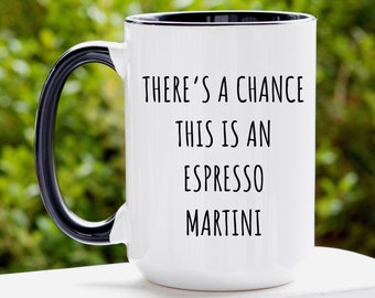 May include: White ceramic coffee mug with a black handle and black rim. The mug has the text "There's a chance this is an espresso martini" printed on it.