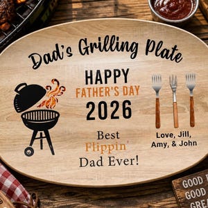 May include: Oval wooden grilling plate with text "Dad's Grilling Plate" and "Happy Father's Day 2026". Includes a grill graphic, three forks, and the words "Best Flippin' Dad Ever!" and "Love, Jill, Amy, & John".