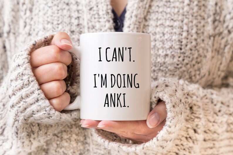 May include: White coffee mug with black text that reads "I can't. I'm doing Anki."