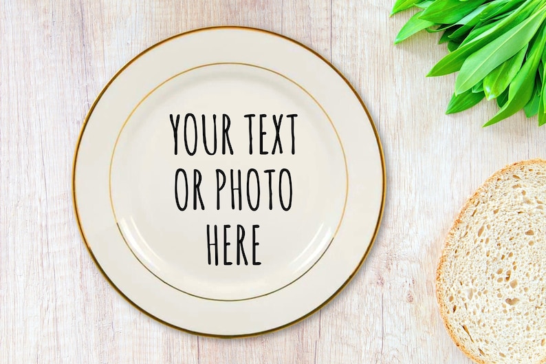 May include: A white ceramic plate with a gold rim. The plate has the text "YOUR TEXT OR PHOTO HERE" written in black.