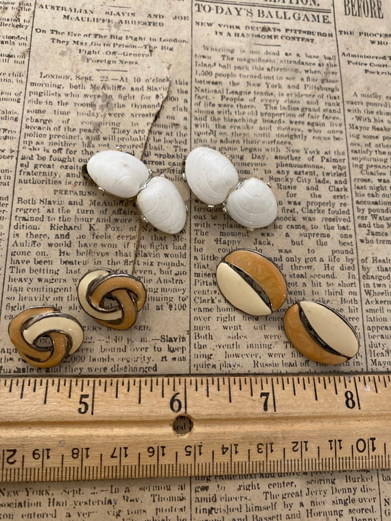 Set of three clip on earrings.