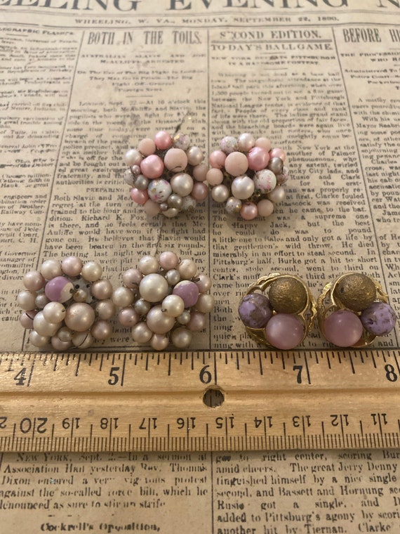 Set of three clasp back earrings in shades of pink